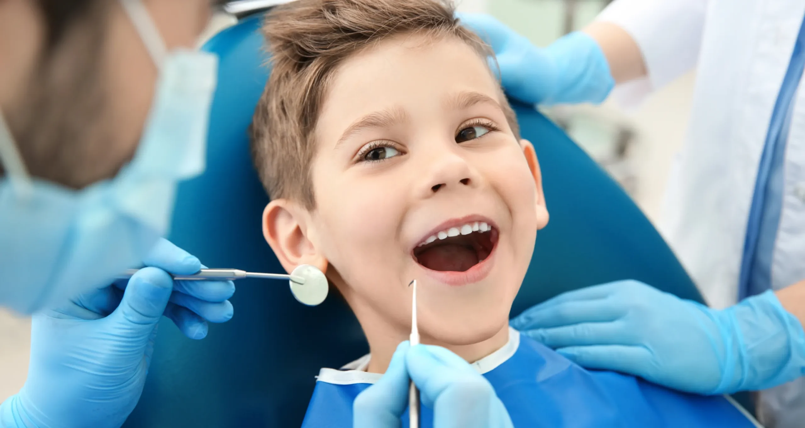 Photo of a boy smiling in a dental chair